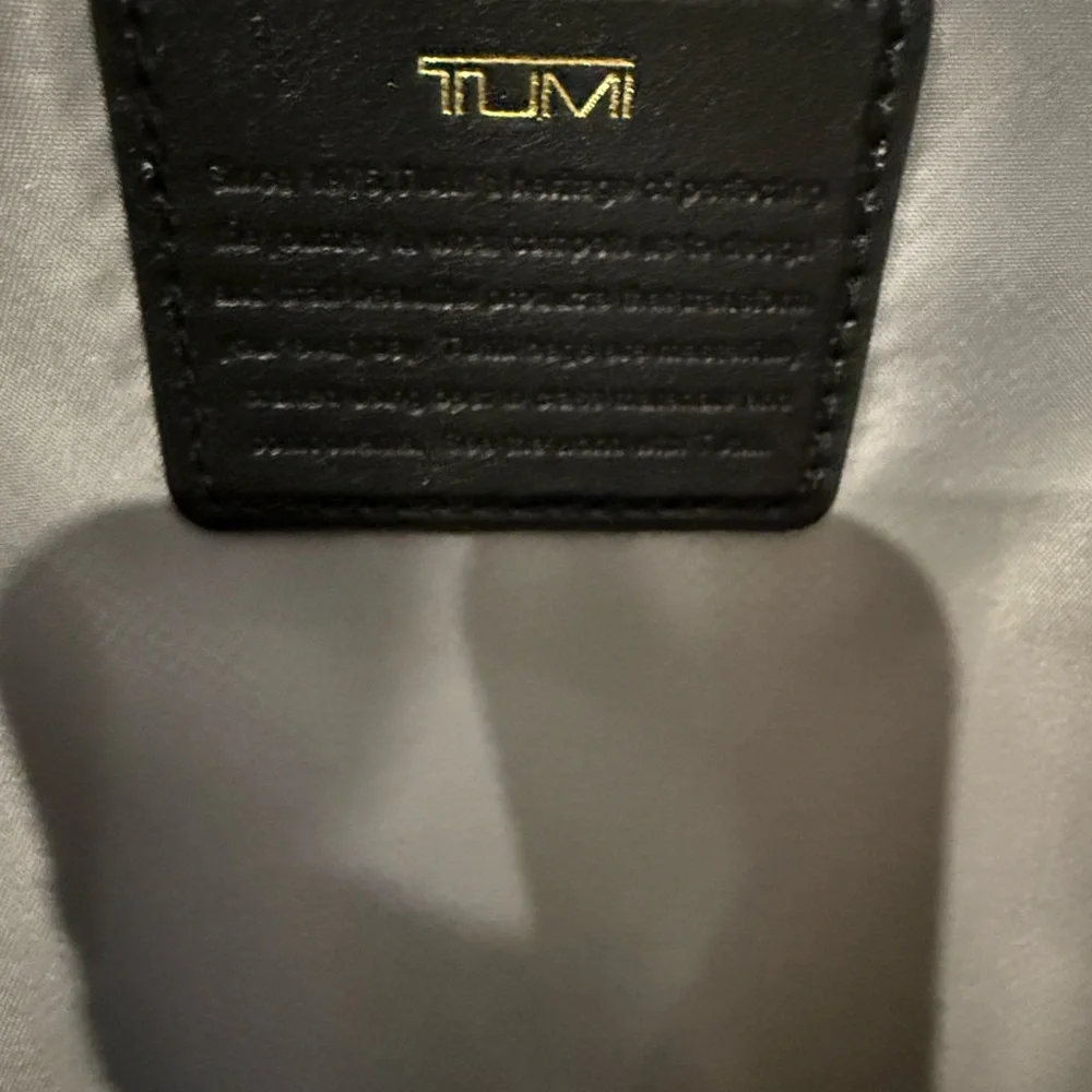 Tumi Backpack in Black with Gold Details and multiple components